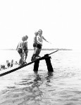 Children line up for their turn on the wooden diving board at Bulcock Beach, ca 1949